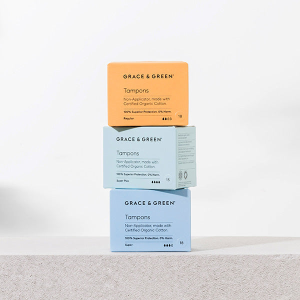 Image of 3 boxes of eco-friendly tampons made from sustainable materials, with a blue and orange packaging